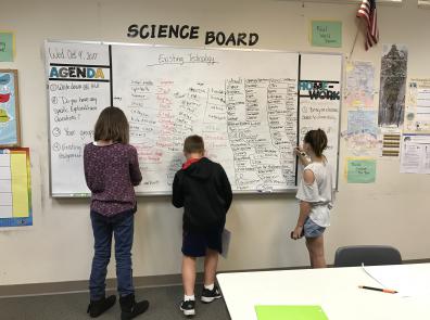 Engaged STEM kids from NH in front of a white board