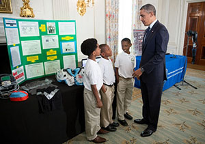 2012 winners presenting their idea to former President Obama